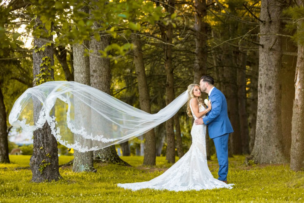 Bride and Groom with veil blowing in the wind at Perona Farms Wedding in New Jersey